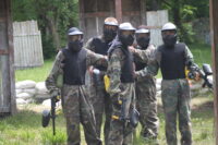 group of paintball players at a party together holding hands