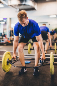 Fit man lifting weights at the gym. Sporty lifestyle and bodybuilding.