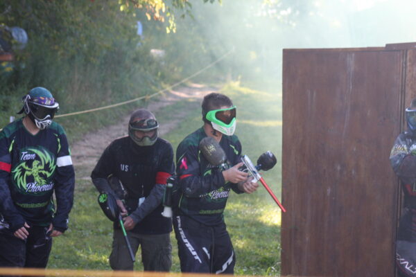 three adult males playing paintball