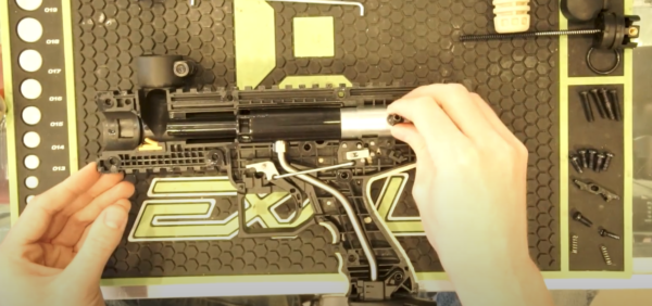 someone working on a paintball marker