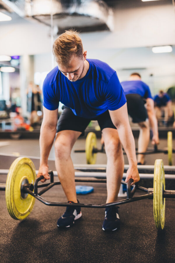 Fit man lifting weights at the gym. Sporty lifestyle and bodybuilding.